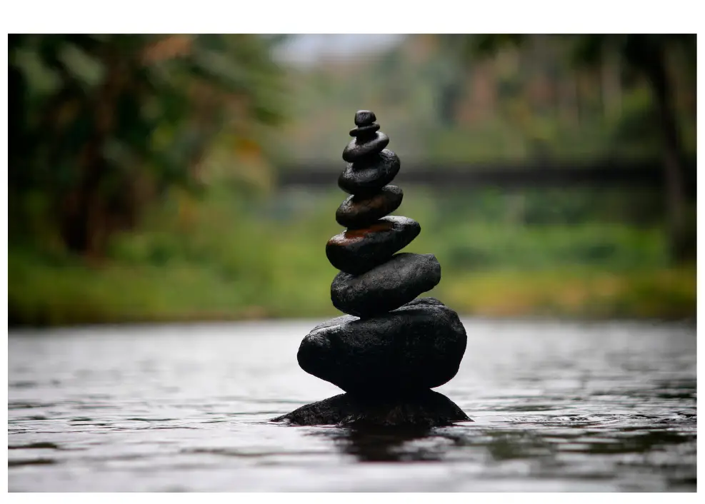 Picture of a cairn of dark rocks.